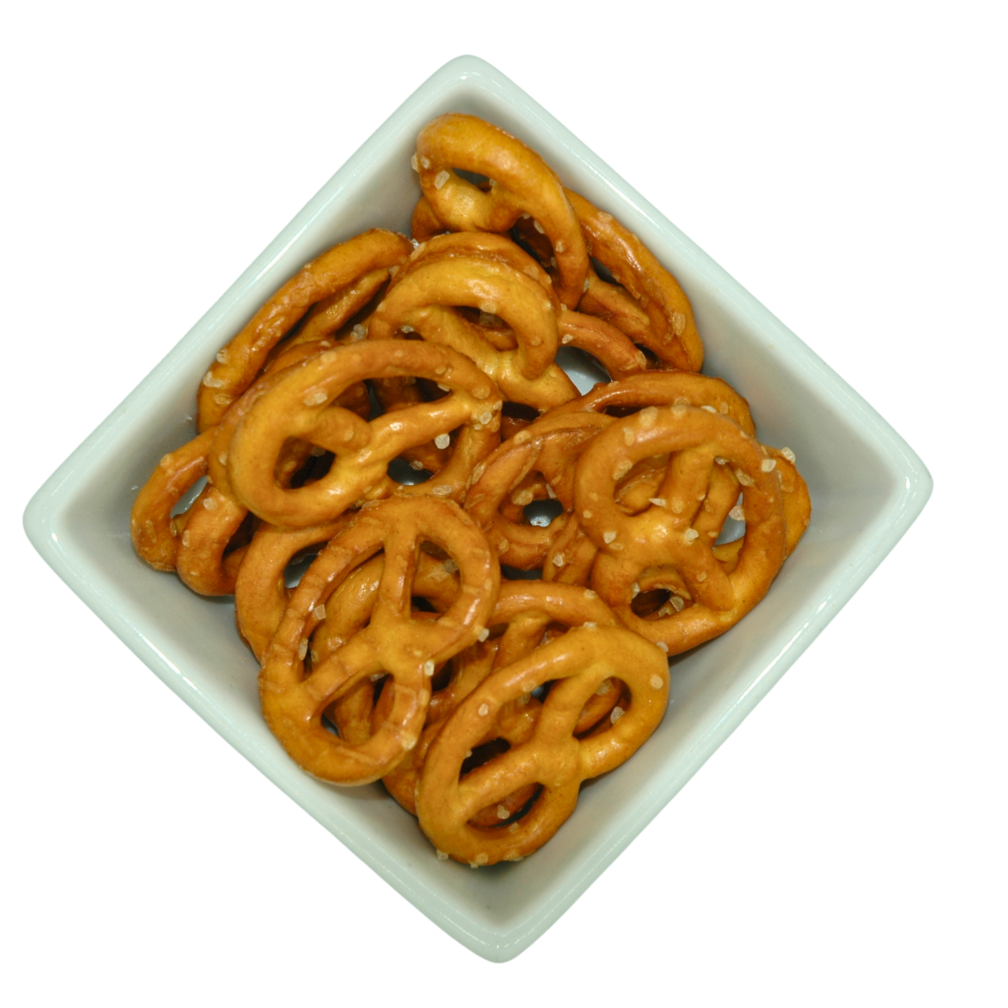 Pretzels covered in large salt crystals n a square white bowl on a white background