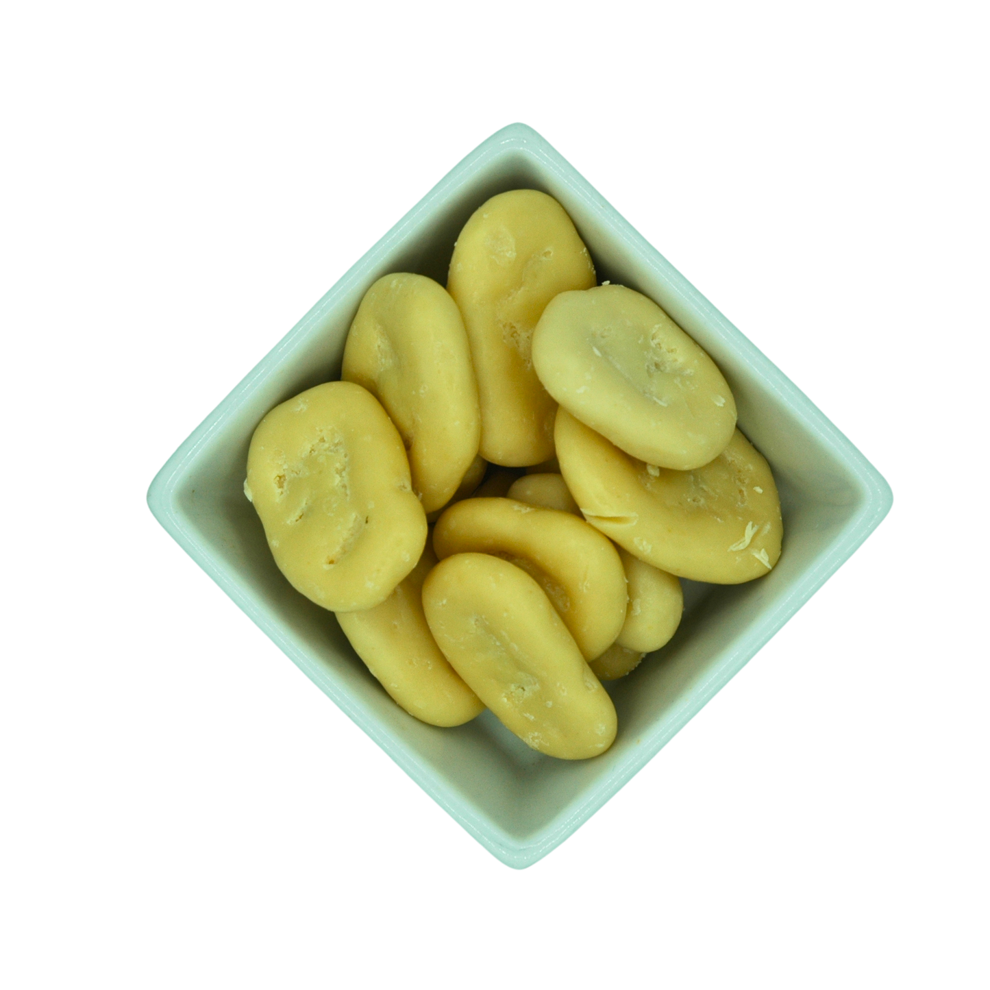 White ceramic bowl filled with yellow yoghurt coated banana chips on a white background