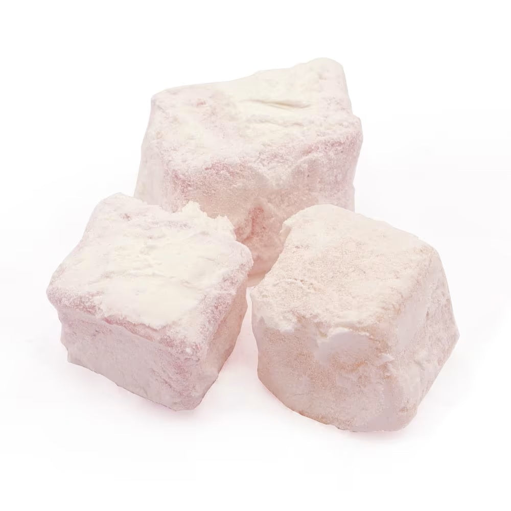 Three pieces of white confectionery on a white background