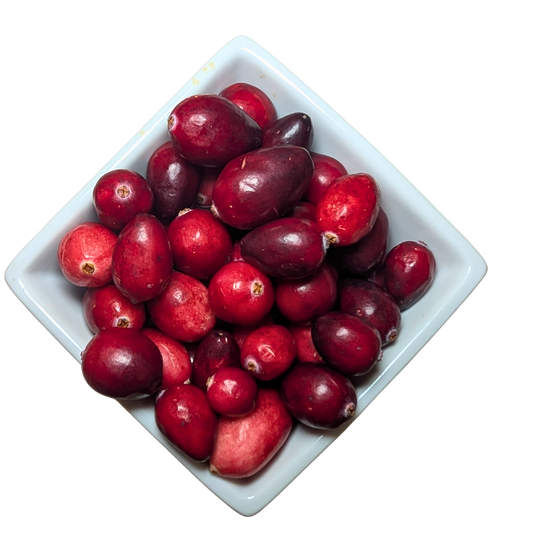 White square bowl filled with red cranberries on a white background