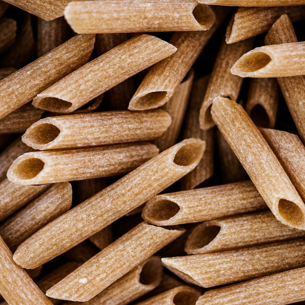 Close-up of a pile of brown penne pasta