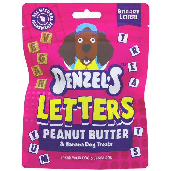 A package of Denzel's Letters Peanut Butter & Banana Dog Treats, featuring a bright pink bag with a cartoon dog wearing a blue cap and colorful letter-shaped treats.