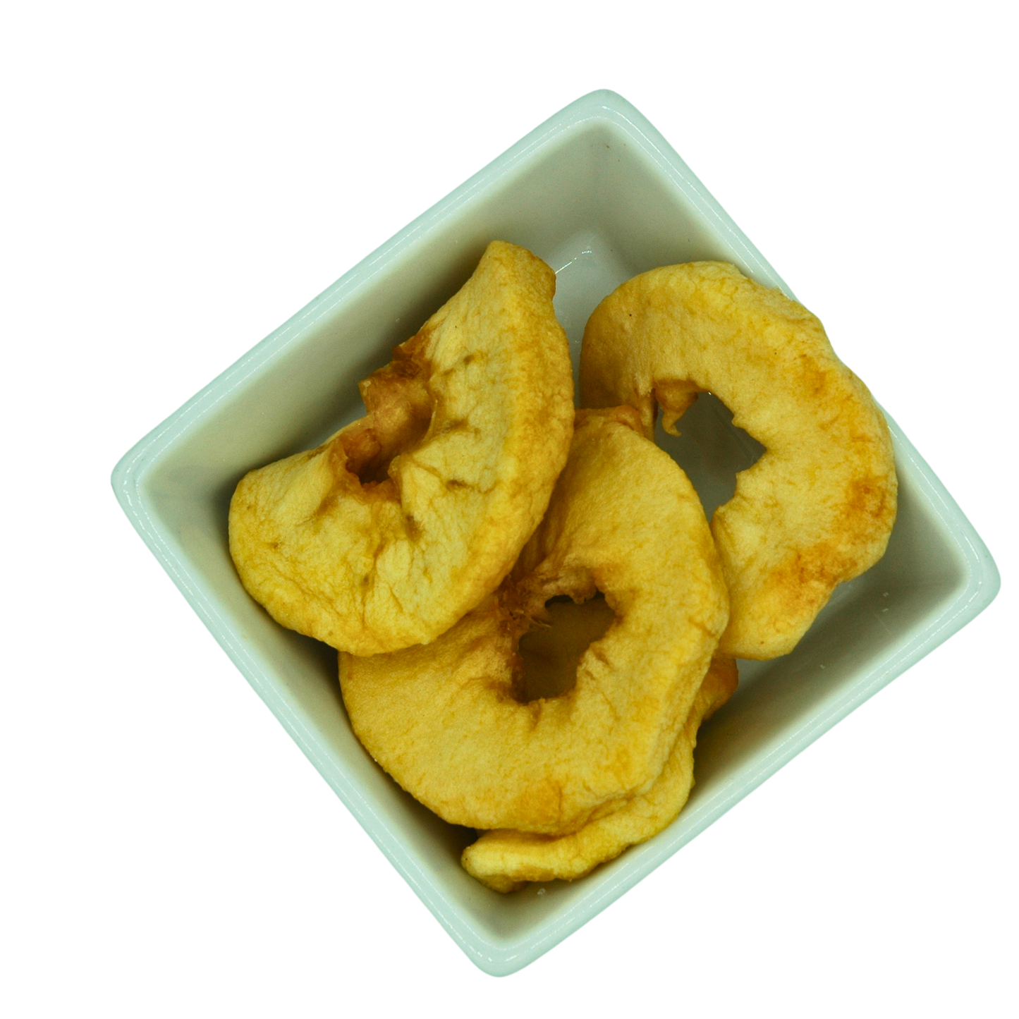 Dried apple slices in a white square bowl on a white background