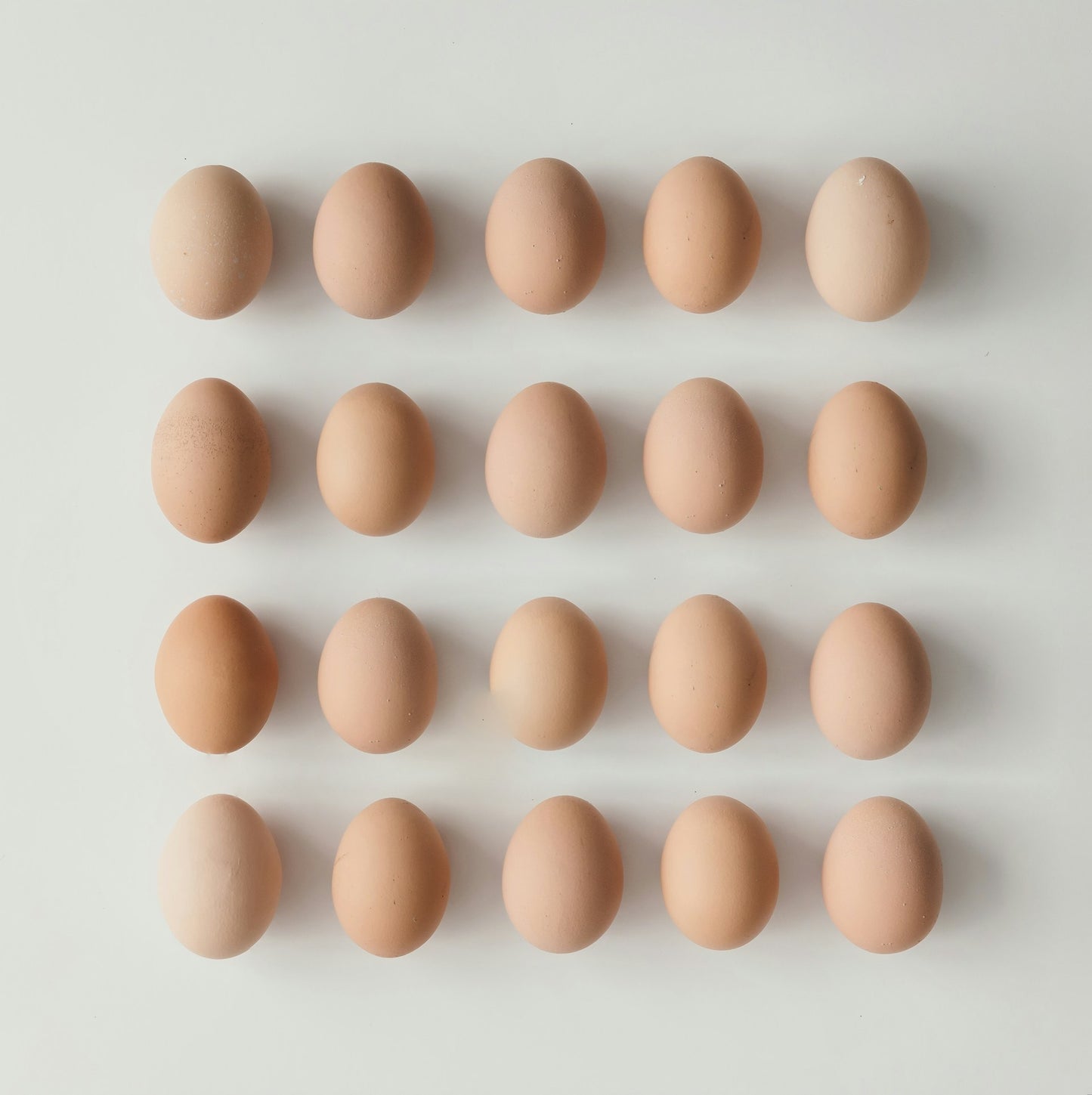 Pattern of brown eggs on a light gray background