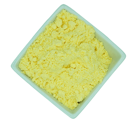 Yellow powder fine polenta in a white container on a white background