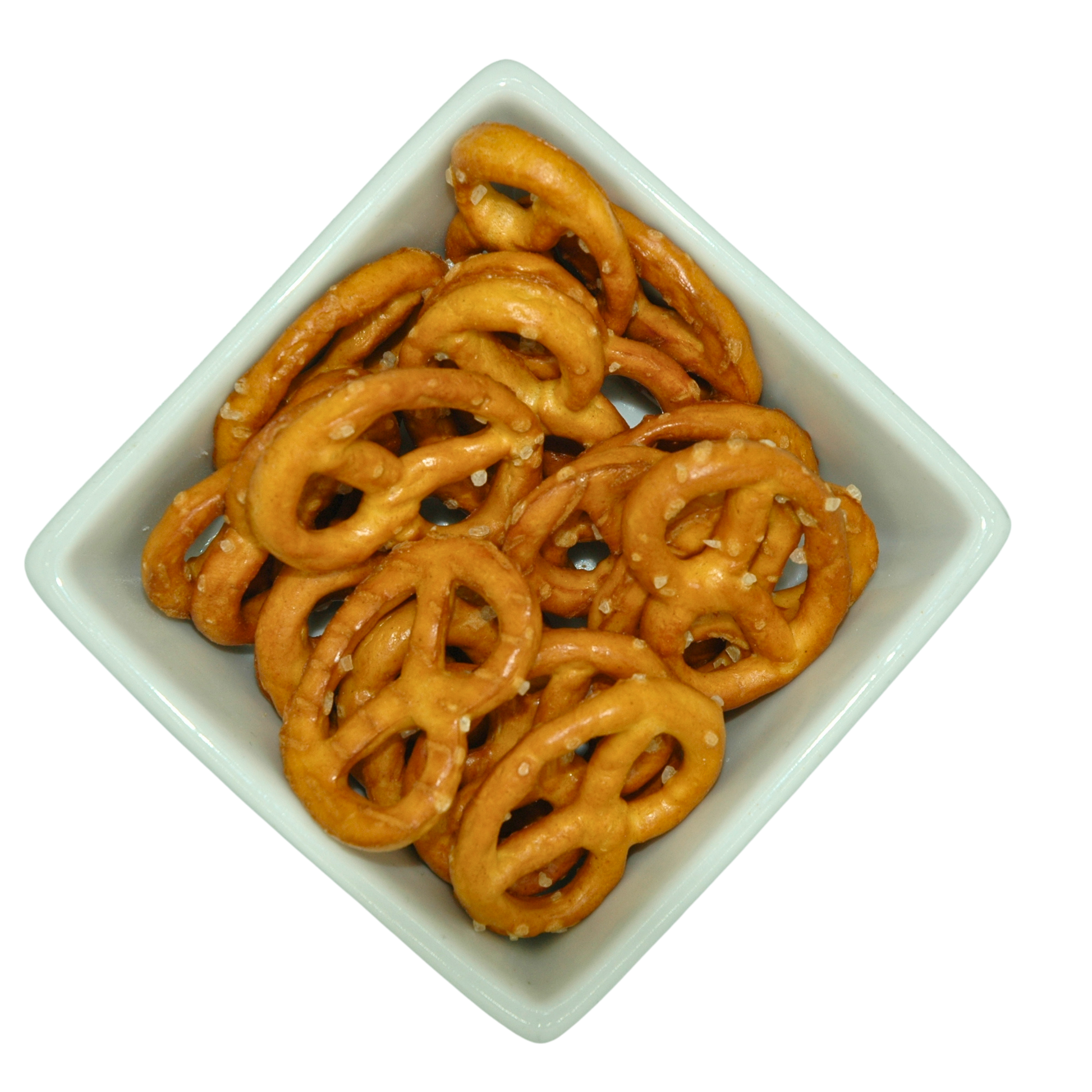Pretzels covered in large salt crystals n a square white bowl on a white background