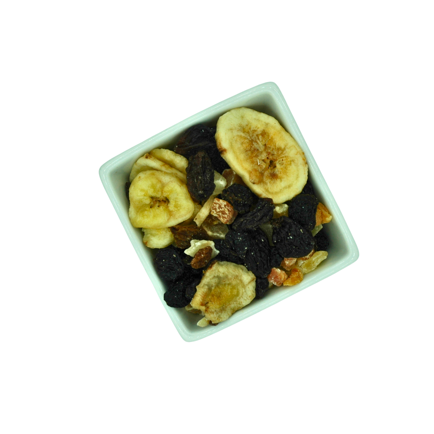 Dried fruits including bananas and raisins in a square white bowl on a white background