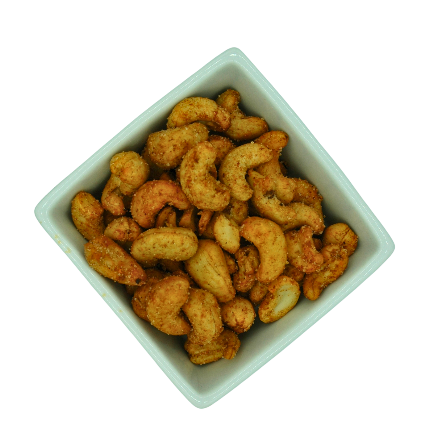 White bowl filled with roasted cashews on a white background