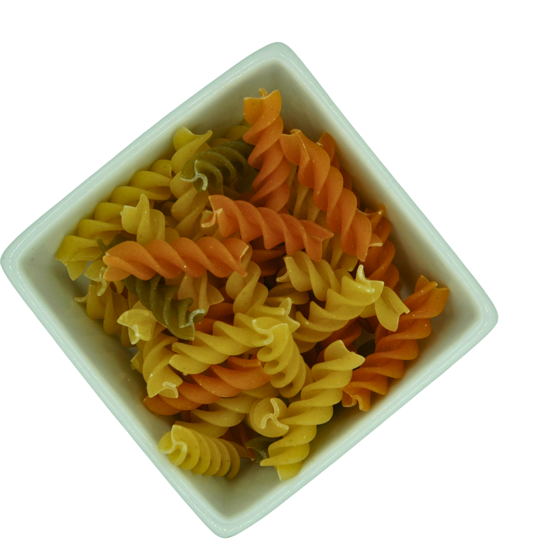 Colorful fusili pasta in a white bowl on a white background