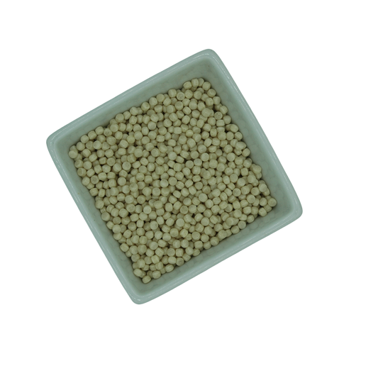 Square white container filled with large couscous grains on a white background