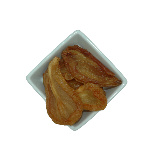 Dried pear halves in a white square bowl on a white background