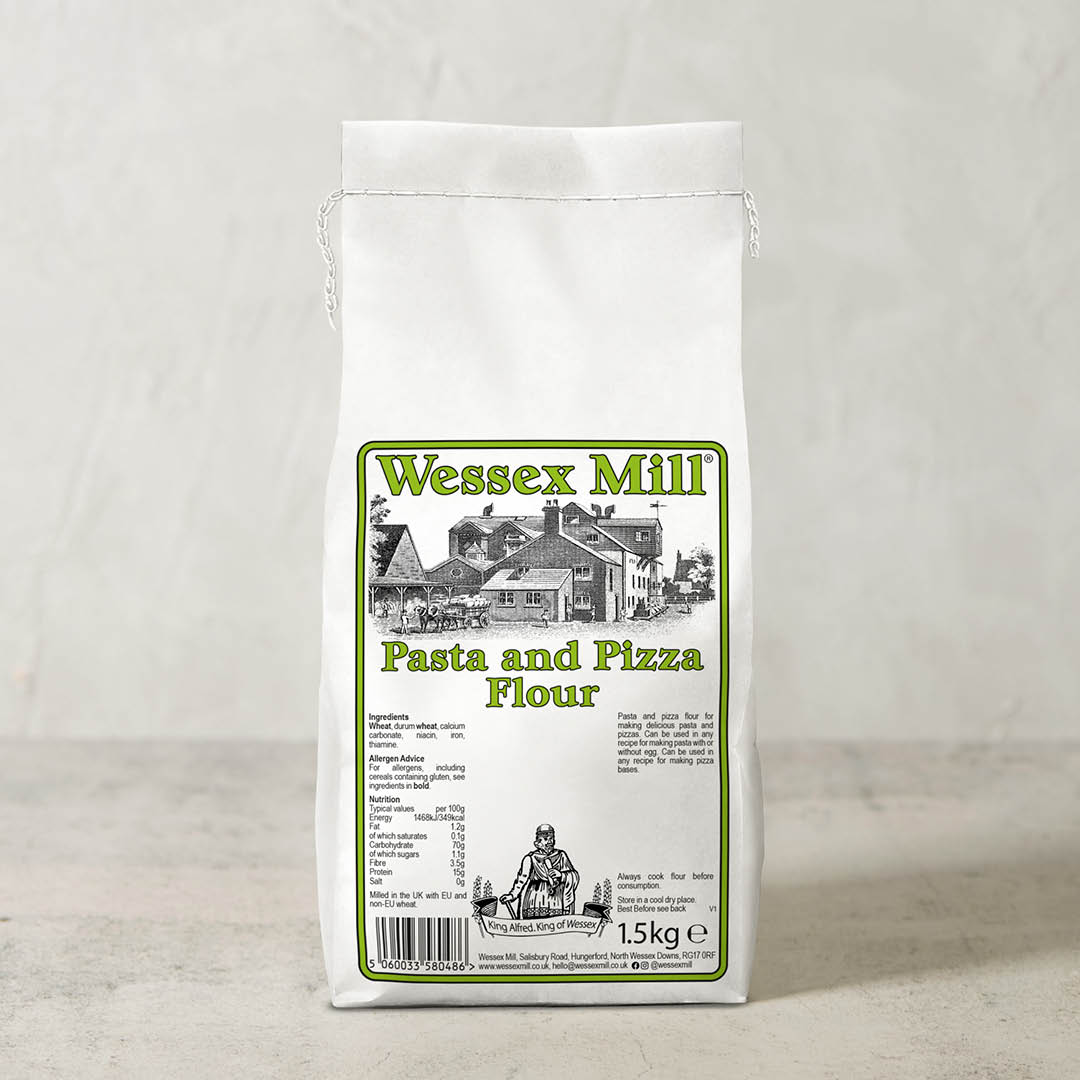 A 1.5kg white bag of Wessex Mill Pasta and Pizza Flour, featuring a green and black label with an illustration of a historic mill building, set against a neutral light gray background.