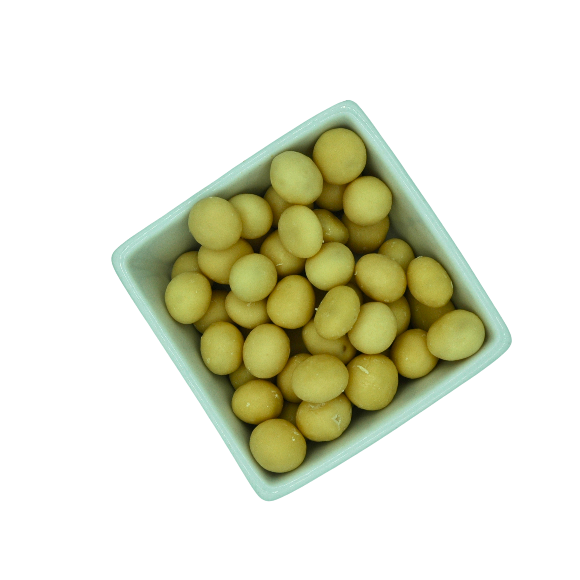 White bowl filled with yellow round yoghurt covered dried fruit on a white background