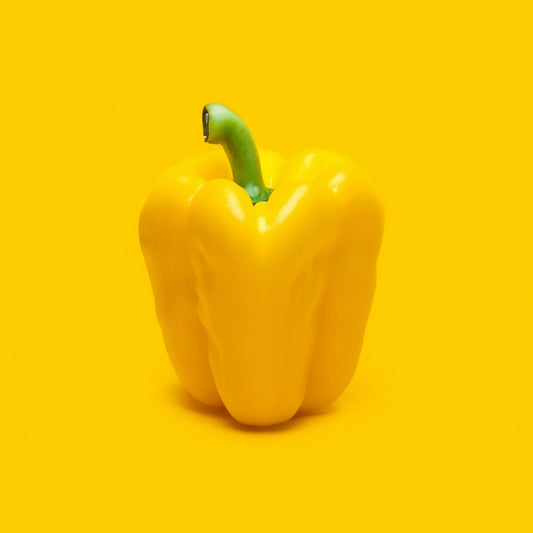 Yellow bell pepper on a yellow background
