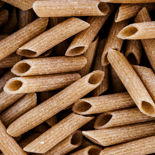 Close-up of a pile of brown penne pasta