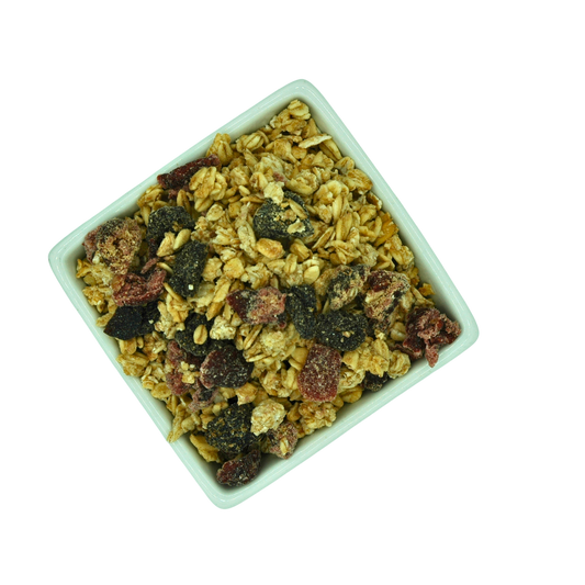 Square bowl filled with a mix of dried fruit and oat granola on a white background