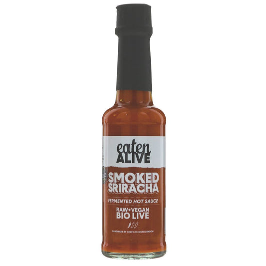 Bottle of smoked sriracha sauce with a black cap on a white background made by eaten alive