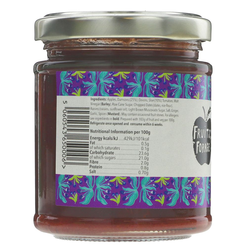 A glass jar of Fruit of the Loom Wild Berry Jam with a silver metal lid and a purple label showing the back nutrition information, on a white background.