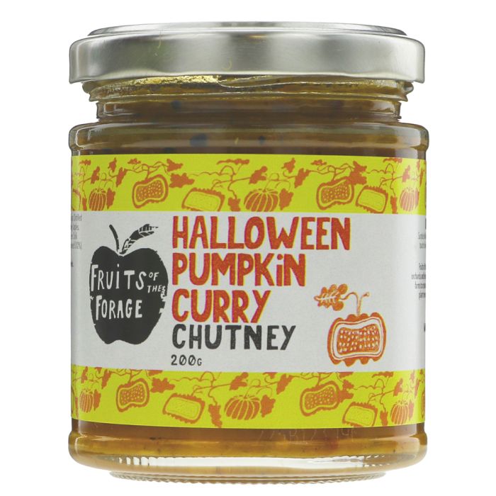 A glass jar of Fruits of the Forage Halloween Pumpkin Curry Chutney with a silver metal lid and a yellow label featuring orange illustrations and red text.