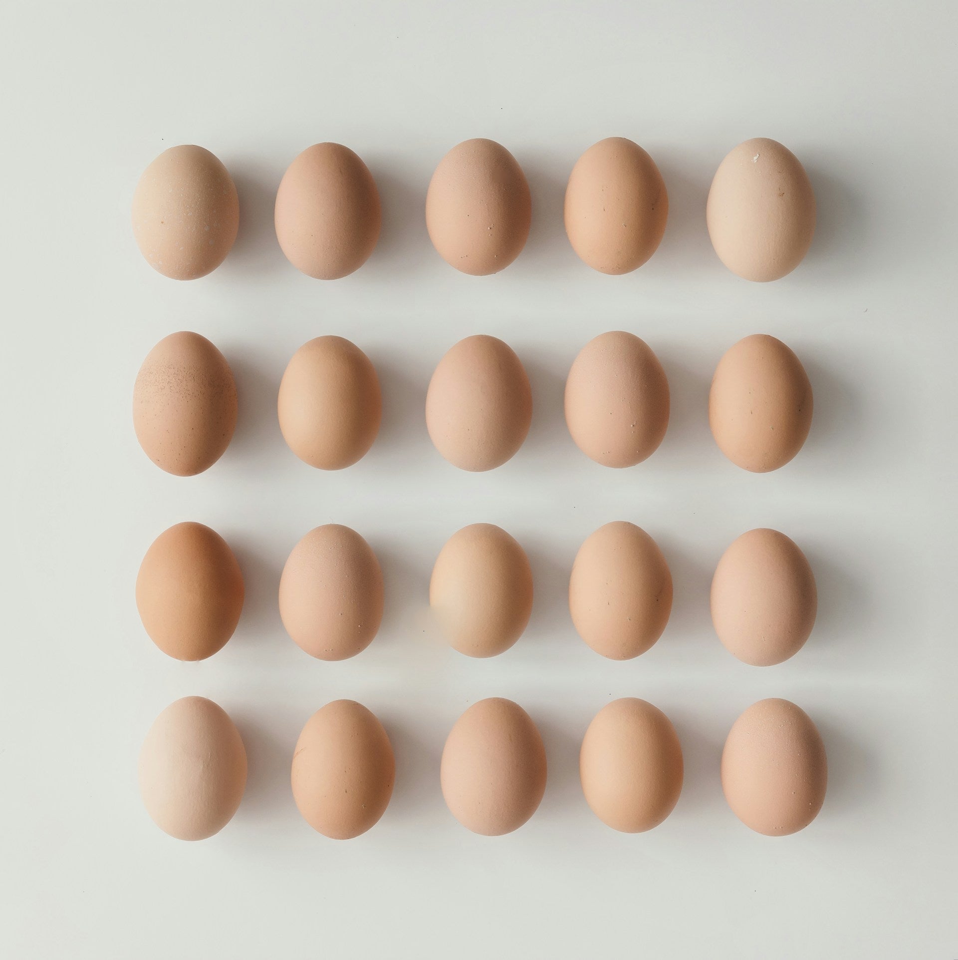 Pattern of brown eggs on a light gray background