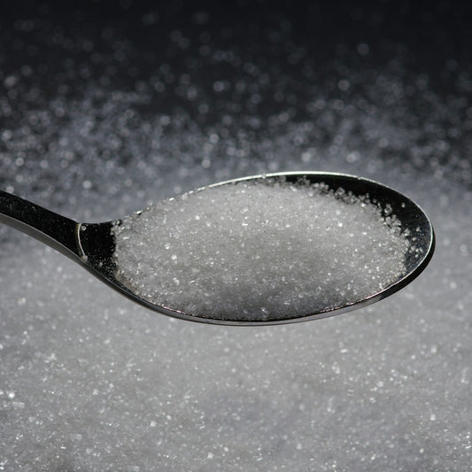 Spoonful of sugar on a dark background