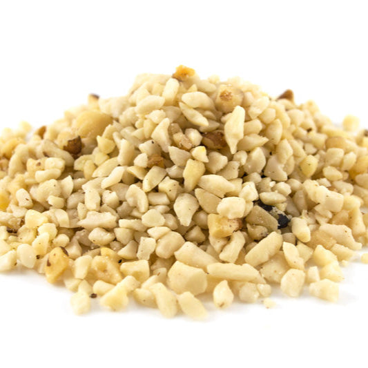 Pile of dried chopped nuts on a white background