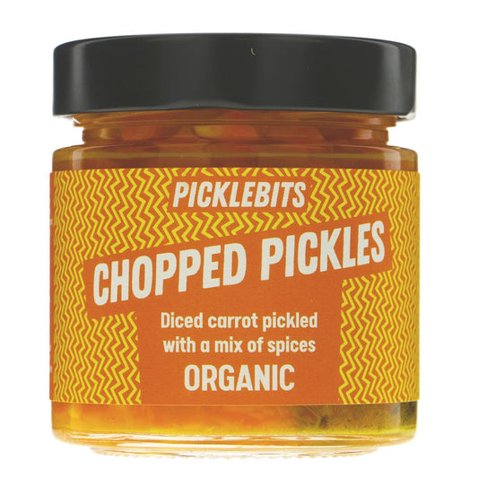 A jar of Picklebits Chopped Pickles, organic diced carrot pickles with a mix of spices, featuring a black lid and a yellow and orange label, shown on a white background.