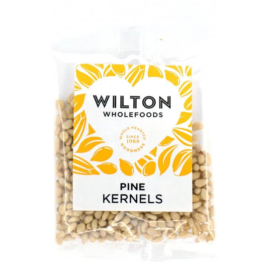 Pack of Wilton Wholefoods Pine Kernels with yellow and white design on a white background