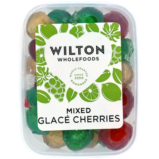 Container of mixed glacé cherries with a Wilton Wholefoods label on a white background