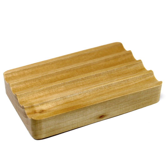 Wooden soap dish with grooves on a white background